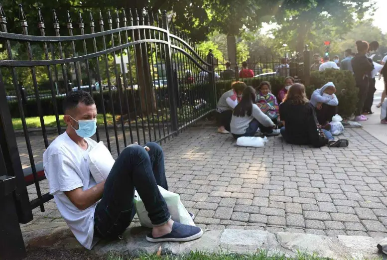 immigrants sitting down outside the court